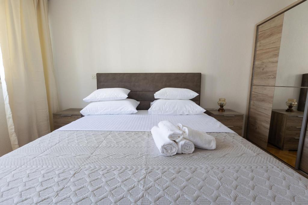 a bedroom with a bed with towels on it at Apartment Srecko in Omiš