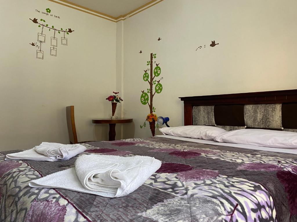 Postel nebo postele na pokoji v ubytování Hostal Arauco