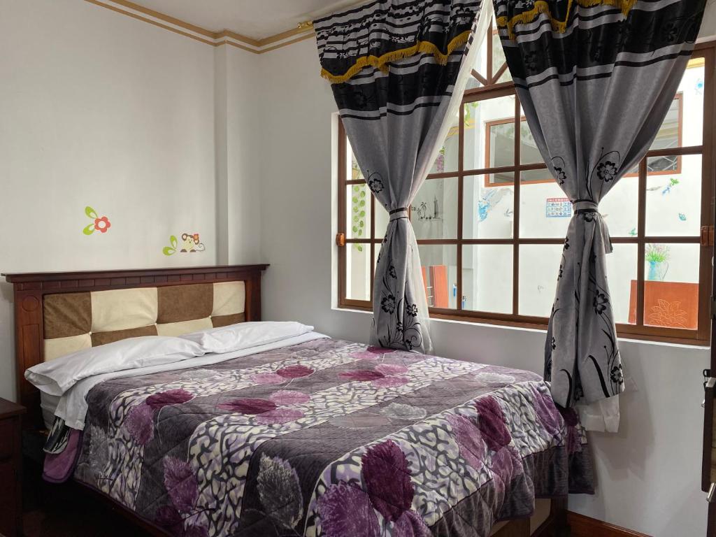 Postel nebo postele na pokoji v ubytování Hostal Arauco