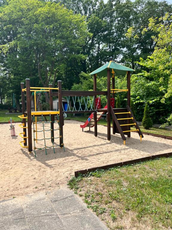 a park with a playground with two swings at Apartamenty Ku Słońcu - Klifowa Jastrzębia Góra in Jastrzębia Góra