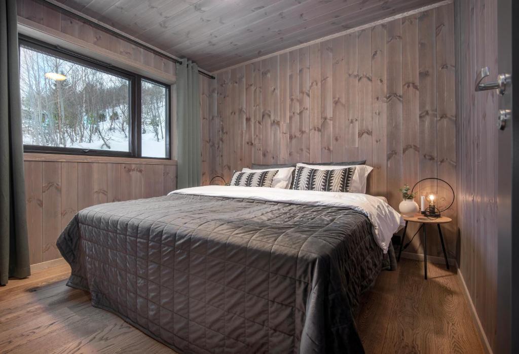 a bedroom with a bed in a room with a window at Exclusive Penthouse Apartment with Sauna - 502 in Stranda