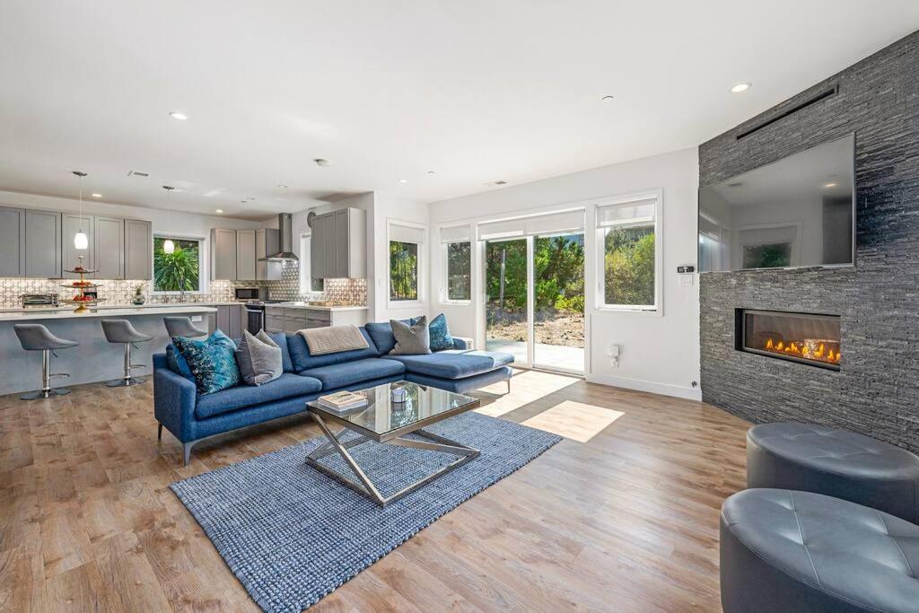a living room with blue couches and a fireplace at Fabulous Beach Get Away - Brand New Beach House in Half Moon Bay