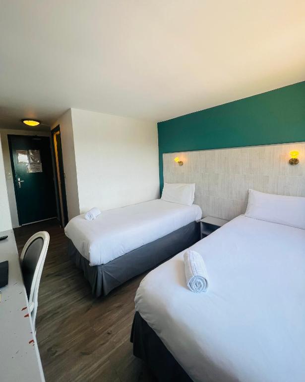 Postel nebo postele na pokoji v ubytování Hôtel Le Forestia