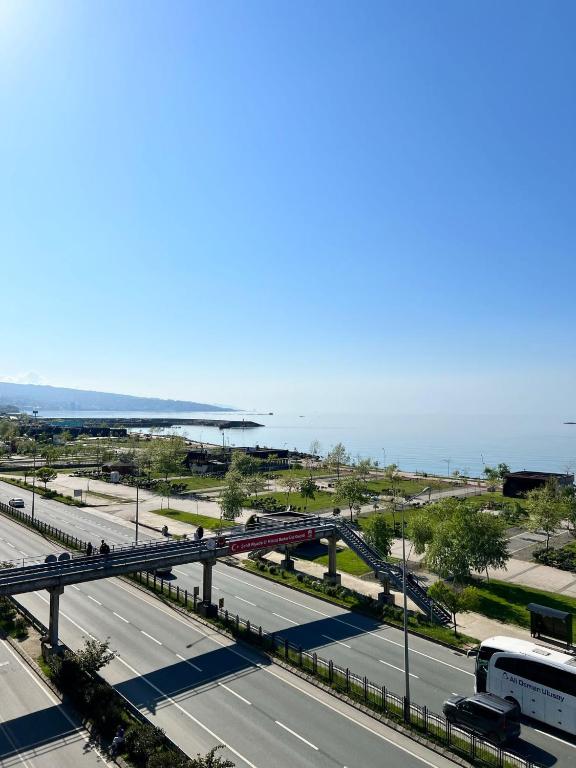 a view of a highway with a bridge and the ocean at Rosella Royal Suit - روزيلا رويال in Arsin