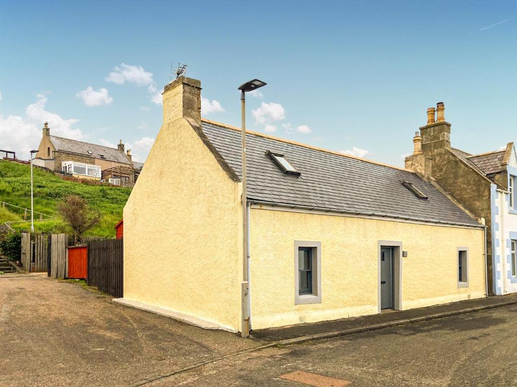 a building with a street light on the side of it at Yardie View in Buckie