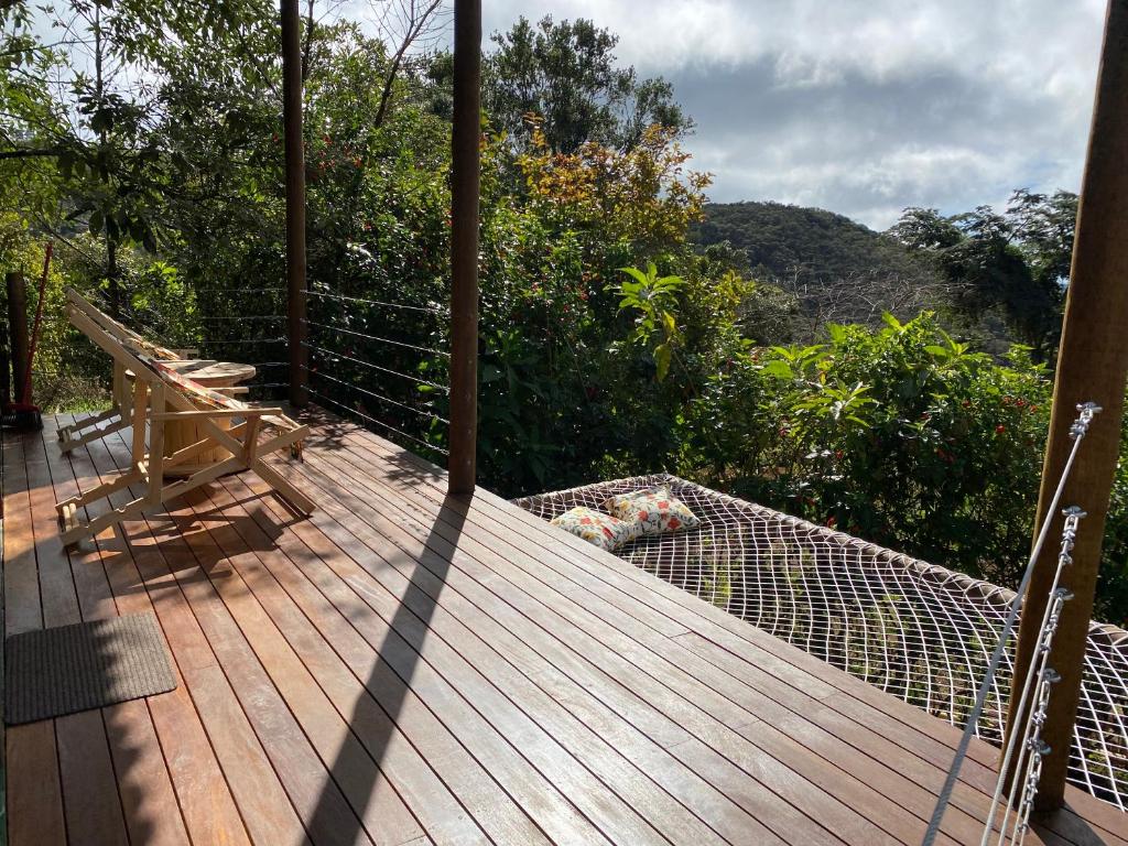 a deck with a hammock and a bench on it at Alto da Villa Loft in Ouro Preto