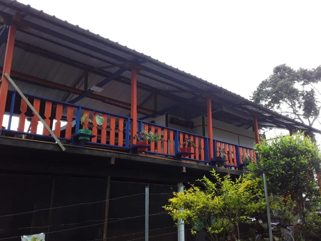 a building with a balcony with plants on it at Casa La Aurora "Posada" in Restrepo