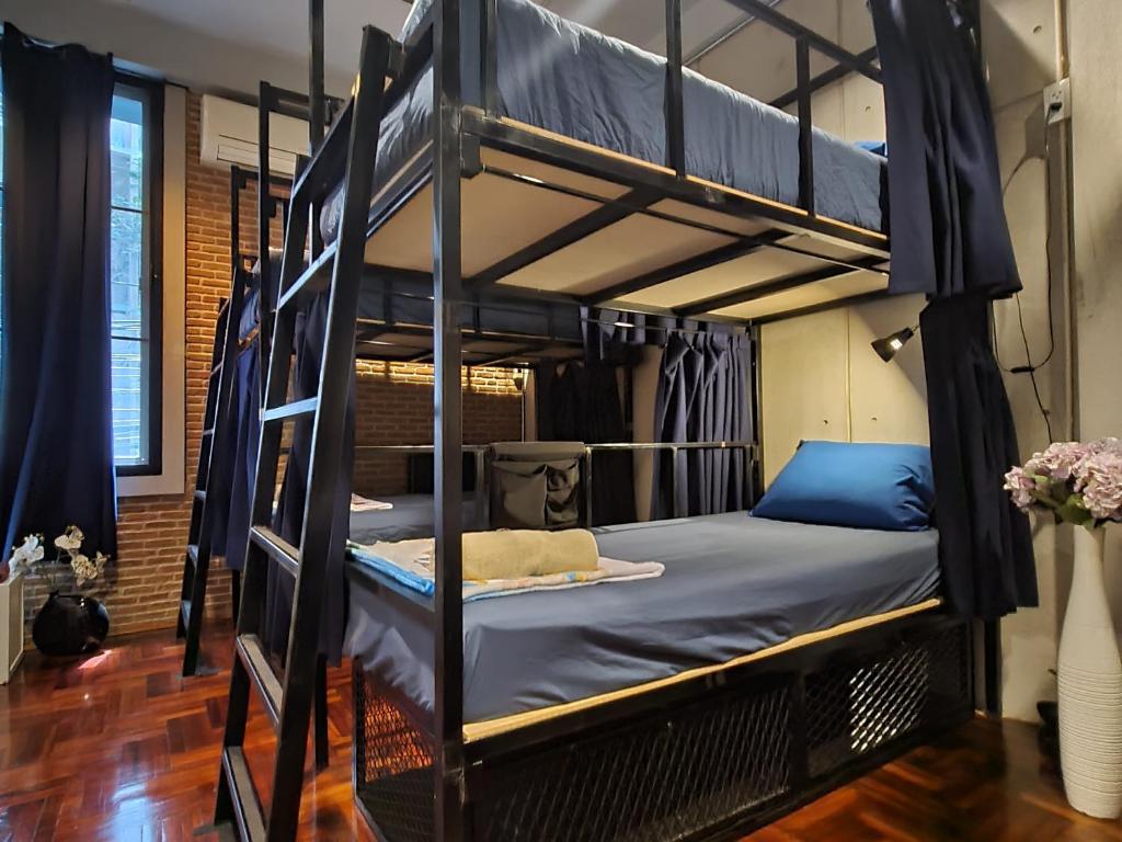 a bedroom with two bunk beds in a room at MEEMAW'S House Hostel in Bangkok