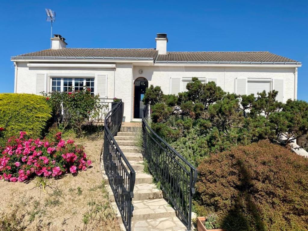 a white house with a staircase in front of it at Chambre cosy RDC avec véranda, jardin privé et wifi, proche plage – Saint-Michel-Chef-Chef - FR-1-306-1256 in Saint-Michel-Chef-Chef