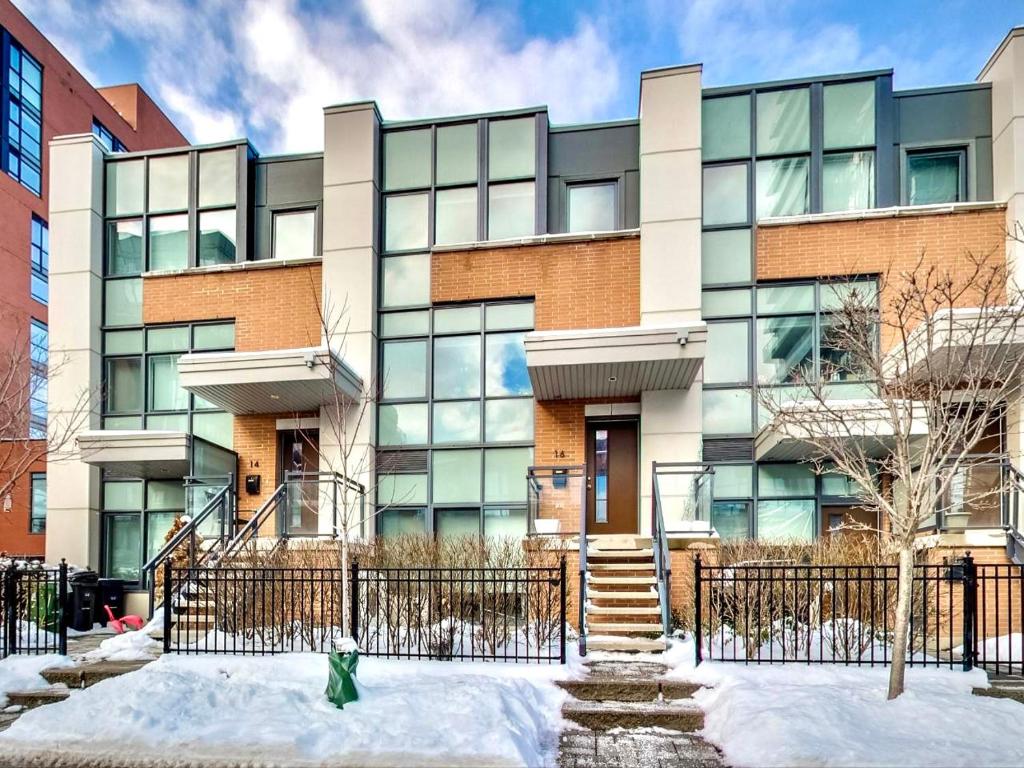 an apartment building with snow in front of it at Home in Downtown in Toronto