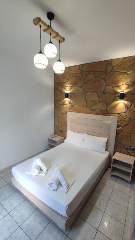 A bed or beds in a room at Alexander Apartments Nea Koutali