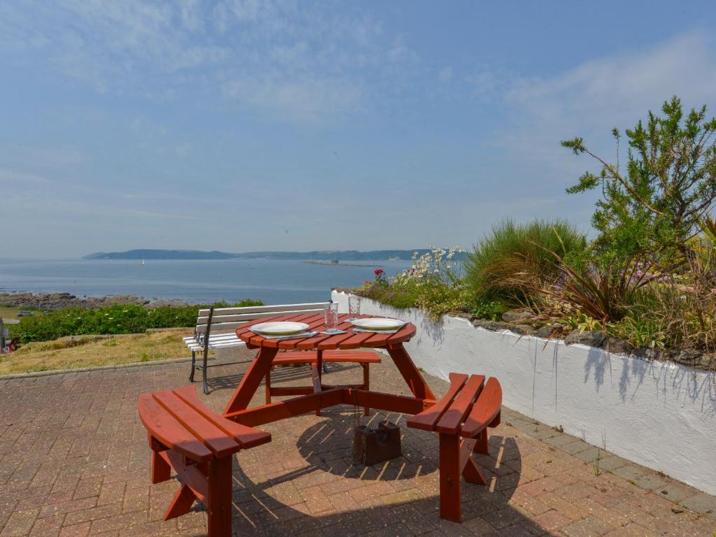 a picnic table and two benches on a brick patio at SoundView in Plymouth