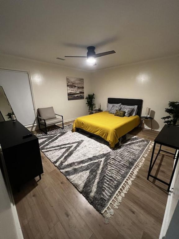 a bedroom with a yellow bed and a rug at Spacious & Cozy - Close to Fort Moore - Pool Table in Columbus