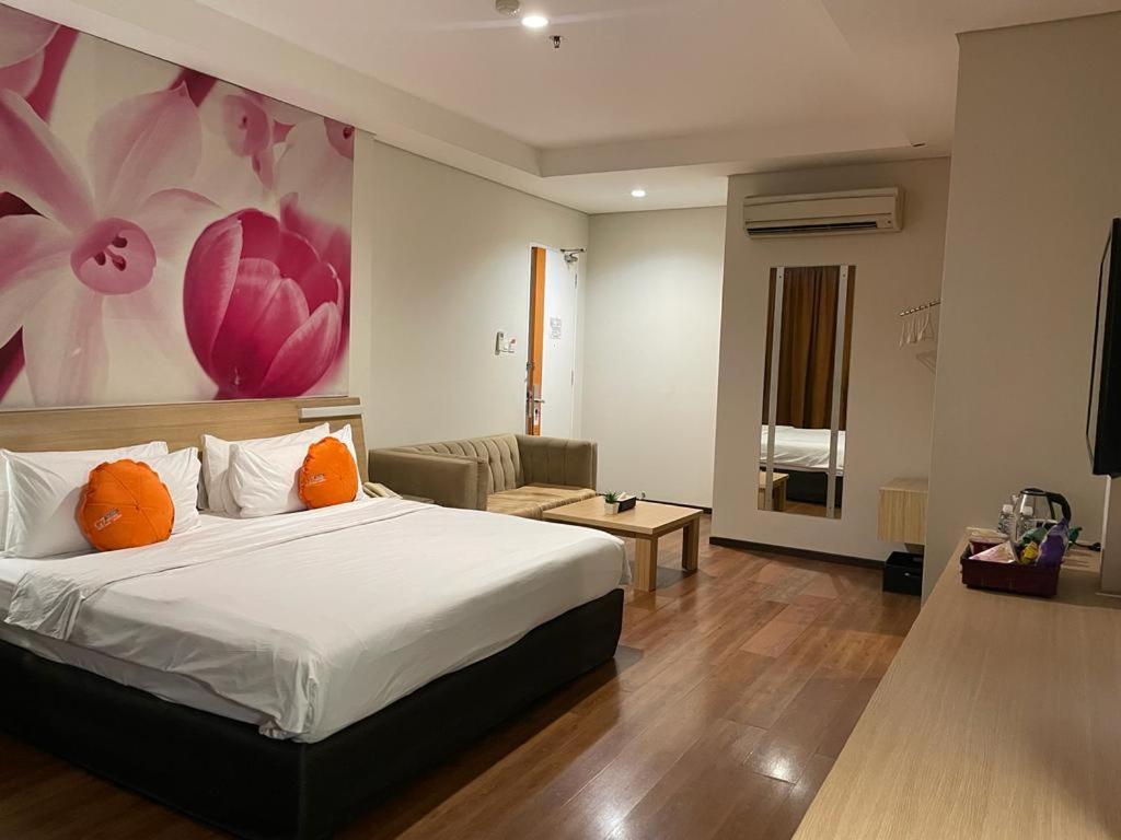 Postel nebo postele na pokoji v ubytování Grand G7 Hotel Pasar baru