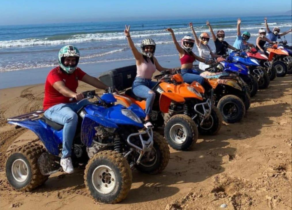 a group of people riding atvs on the beach at Agadir aourir maroc in Aourir