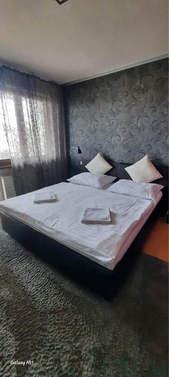 A bed or beds in a room at Penzion Ivka
