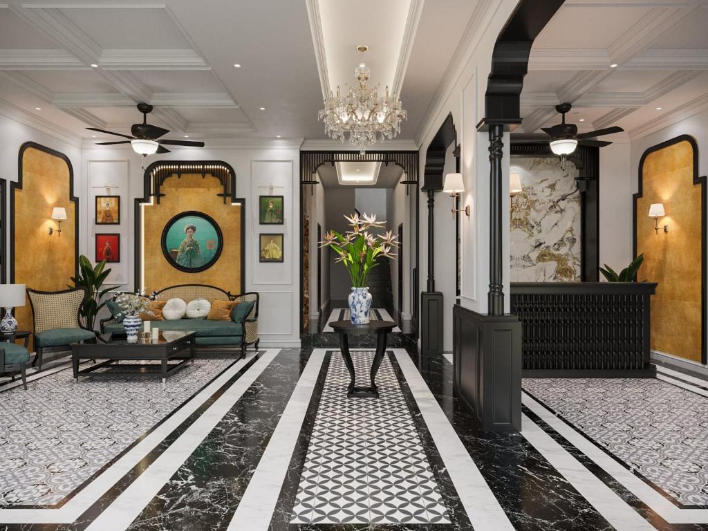 a lobby with a couch and a chandelier at Monaco Hotel in Can Tho