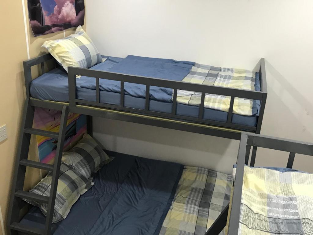 two bunk beds in a room next to a wall at HO GIA AN Home - Căn hộ yên bình in Can Tho