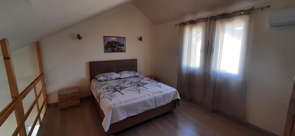 a small bedroom with a bed and a window at Lavender in Budva