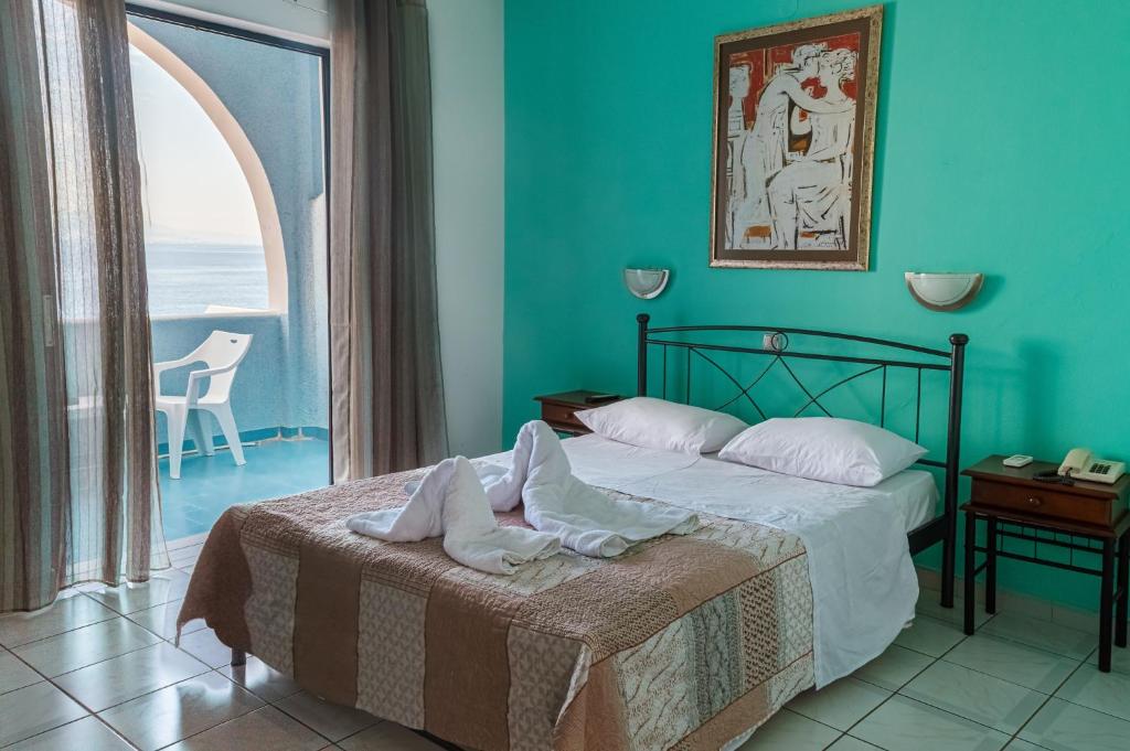 a bedroom with a bed and a large window at Mistral in Souvala