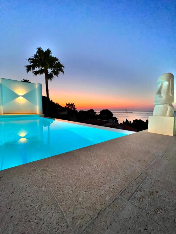 a villa with a swimming pool at sunset at Atalaya Boutique in Denia