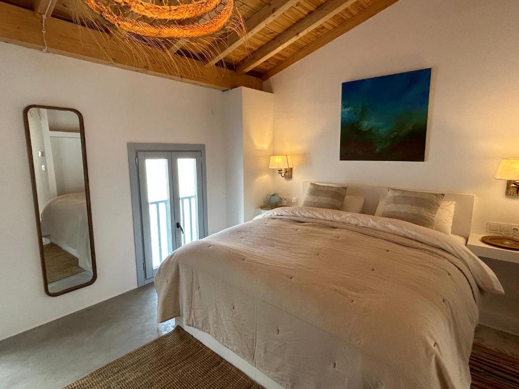 ein Schlafzimmer mit einem großen Bett und einem Spiegel in der Unterkunft Esperanza 9 in Moclín