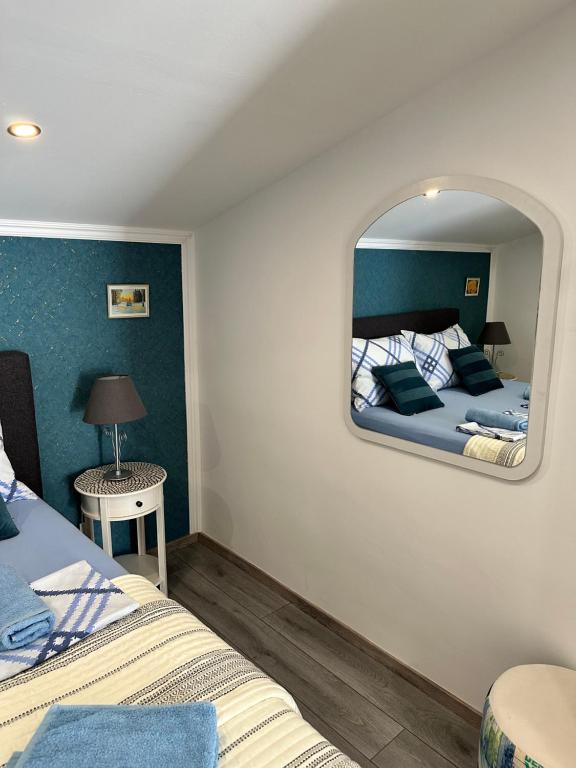 a bedroom with two beds and a mirror on the wall at Lora in Skradin
