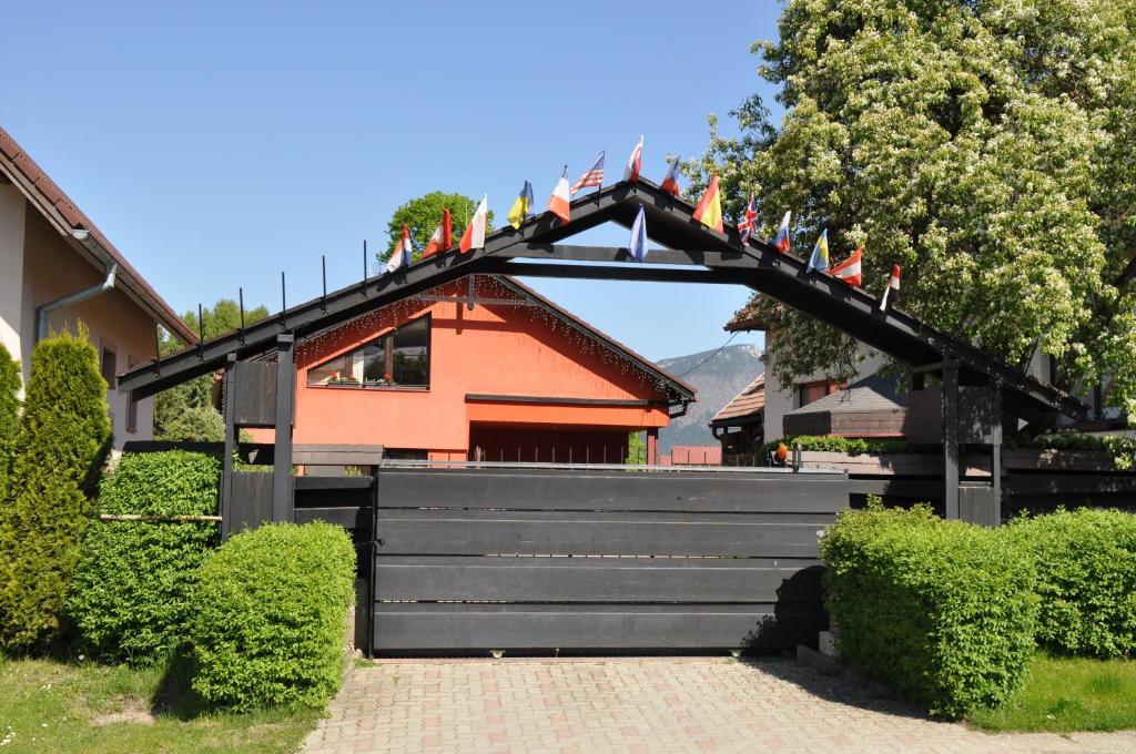 a black gate with flags on it in front of a building at Apartmánový dom Slniečko in Žiar