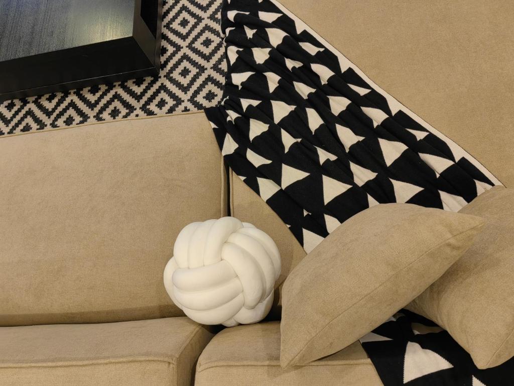 a white object sitting on top of a couch with a flag at Villa 29 Suite A - Home Vacation in Dubai