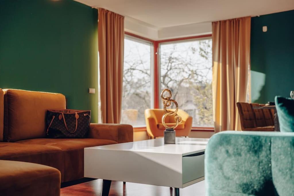 a living room with a white table and chairs at Design 3BD apartment cooking area in architect villa in Prague