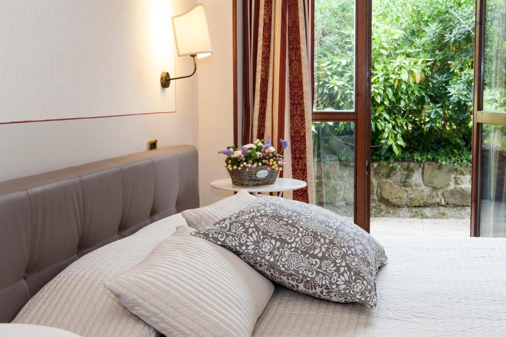 Postel nebo postele na pokoji v ubytování Hotel Monti