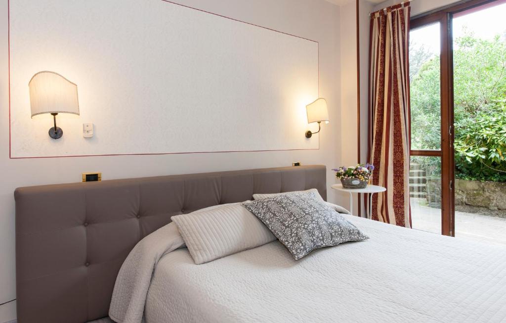 Postel nebo postele na pokoji v ubytování Hotel Monti