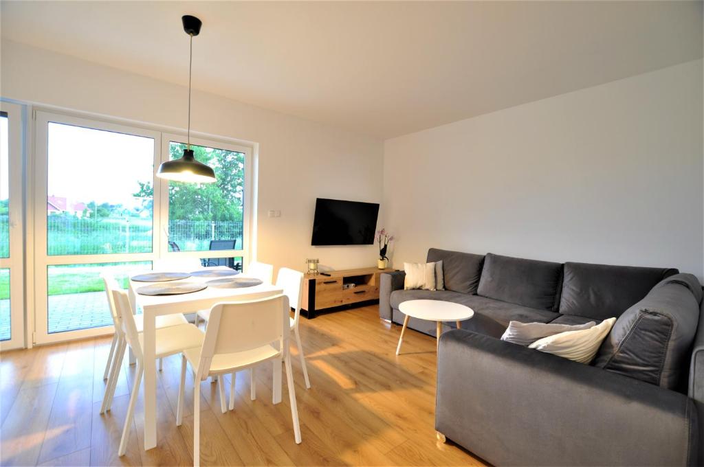 a living room with a couch and a table at Apartamenty Wakacyjna Przewłoka in Przewłoka
