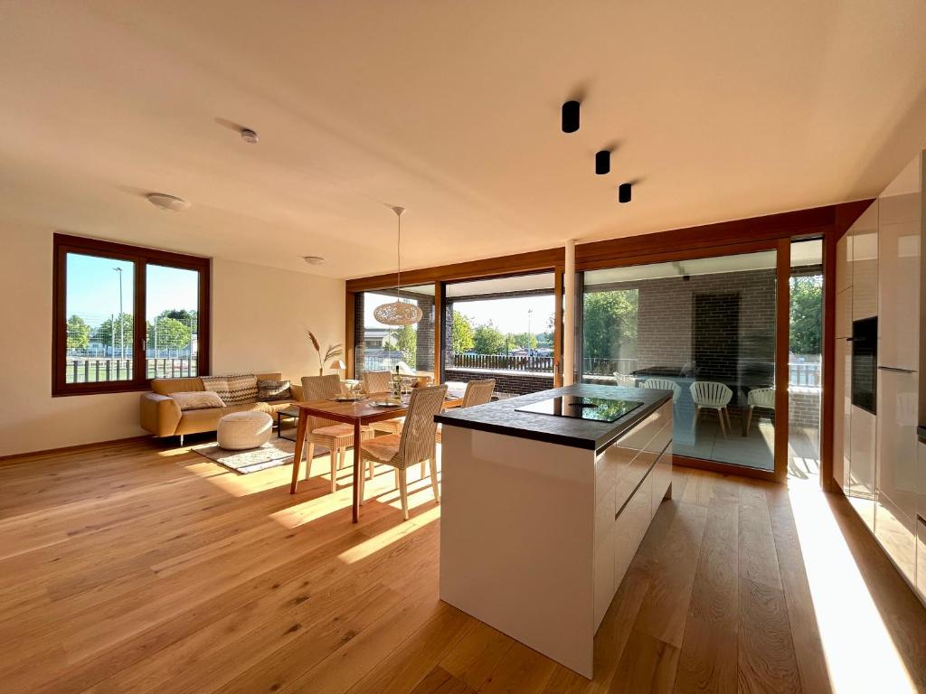 a kitchen and living room with a table and chairs at Seeparkvilla – Wohlfühlen am See und im Grünen in Bregenz