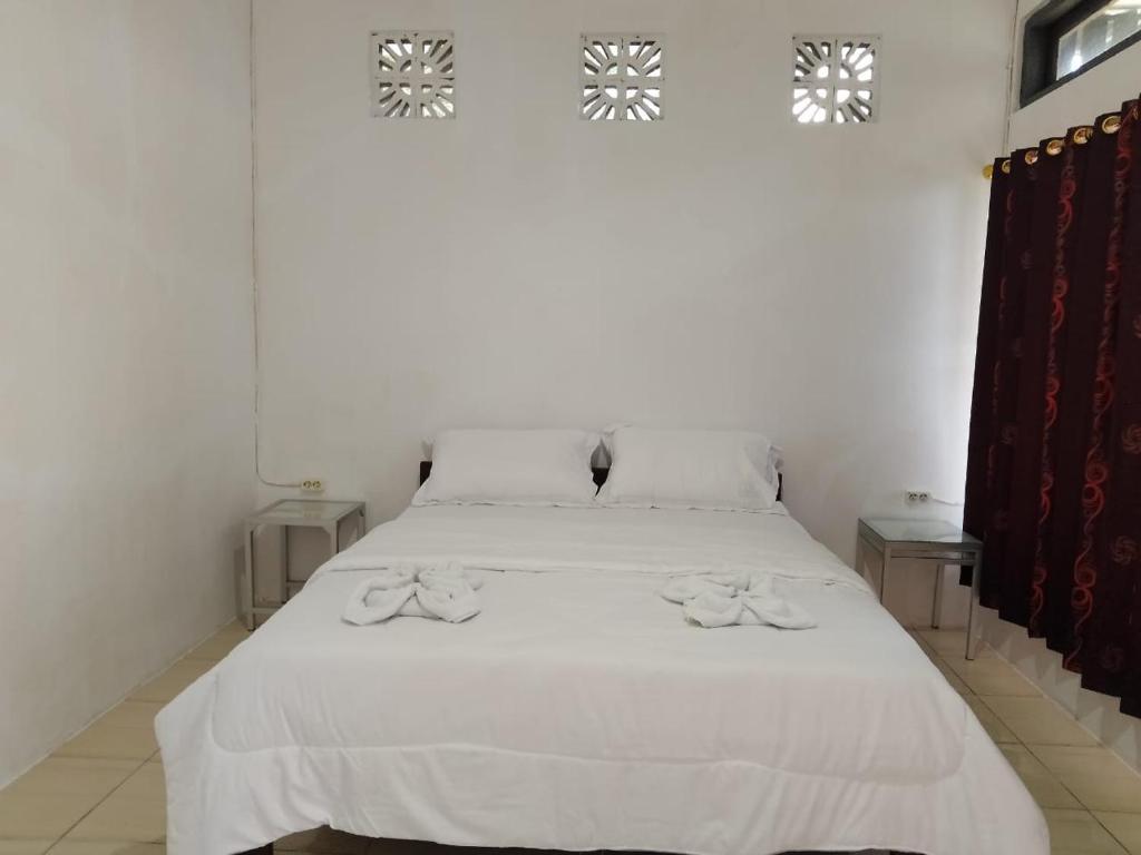 Postel nebo postele na pokoji v ubytování Sao Ria Wisata Lodge