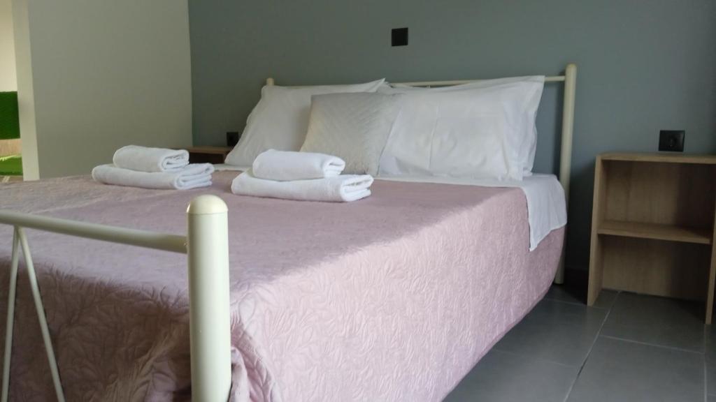 a bedroom with a bed with towels on it at Aelia Boutique Apartments in Argostoli