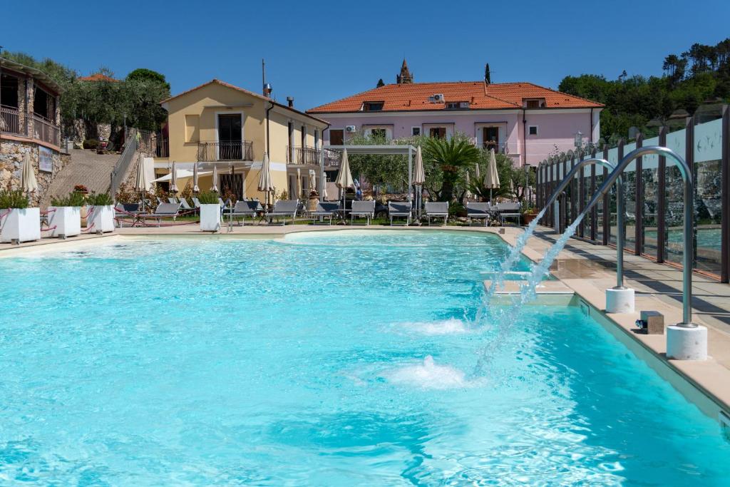 a swimming pool with a water slide at Residence Villa il Casale - appartamenti wellness e piscina riscaldata in Tovo San Giacomo