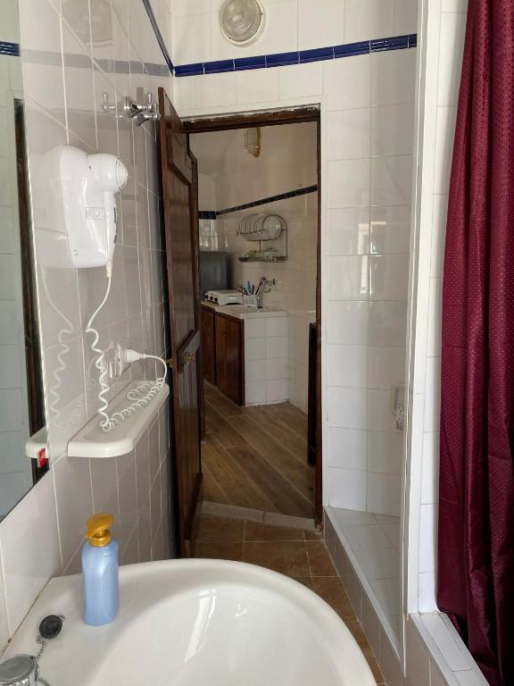 a bathroom with a tub and a sink and a shower at Villaggio La Roccia camping in Lampedusa