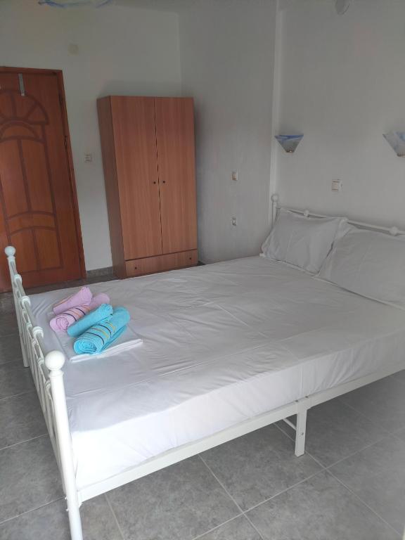 a white bed with two pillows on top of it at Vigla House in Sykia Chalkidikis