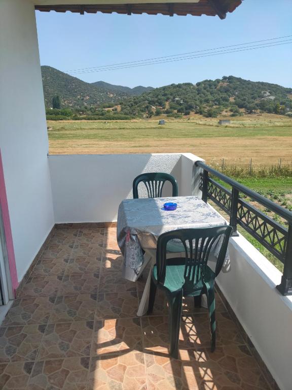 a table and chairs on a balcony with a view at Vigla House in Sykia Chalkidikis