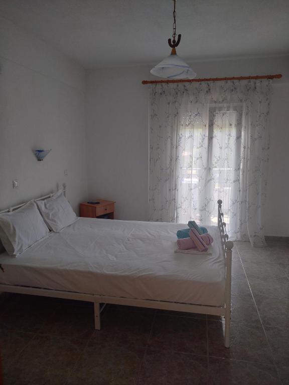 a bed with a pair of shoes sitting on it at Vigla House in Sykia Chalkidikis