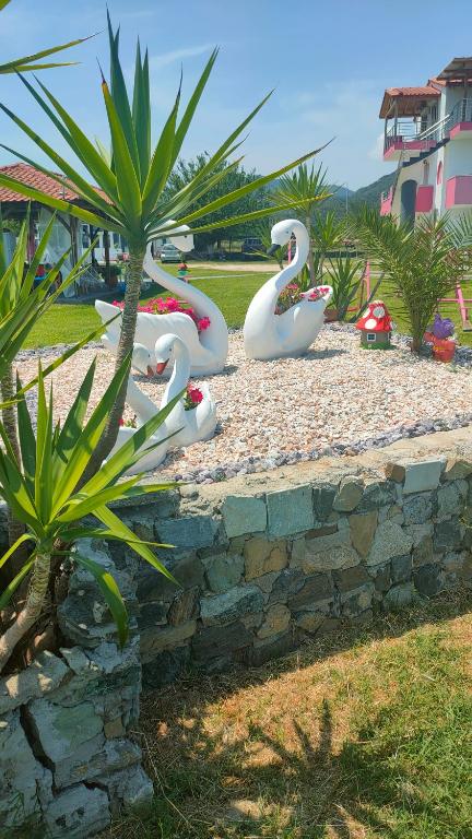 a group of fake swans in a park at Vigla House in Sykia Chalkidikis