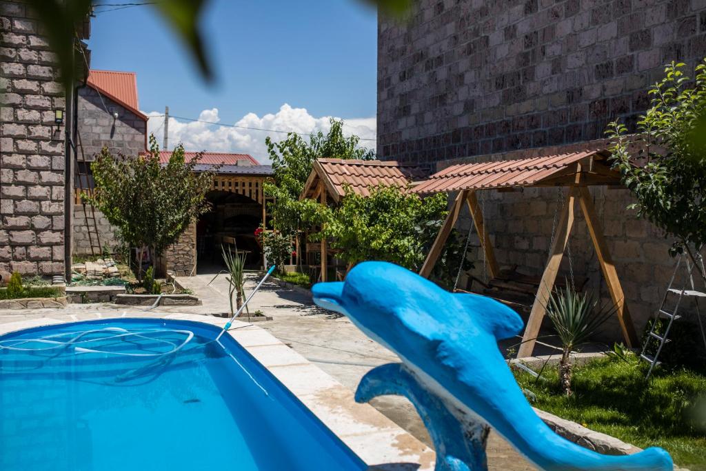 a blue slide in front of a swimming pool at Sweet Home in Yengidzha