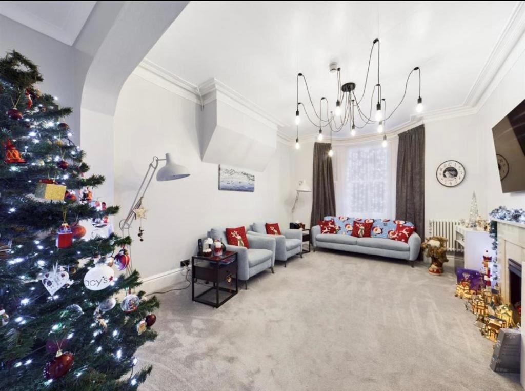 a living room with a christmas tree in it at Sylvern House in Scarborough