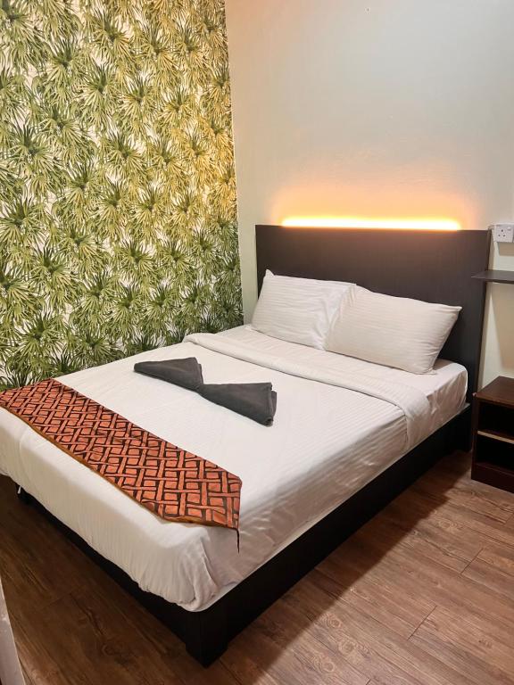 En eller flere senge i et værelse på Hotel Citra