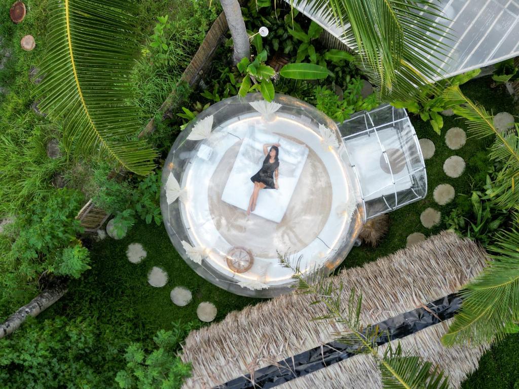 an overhead view of a woman in a circle in a garden at Bubble Siargao in General Luna