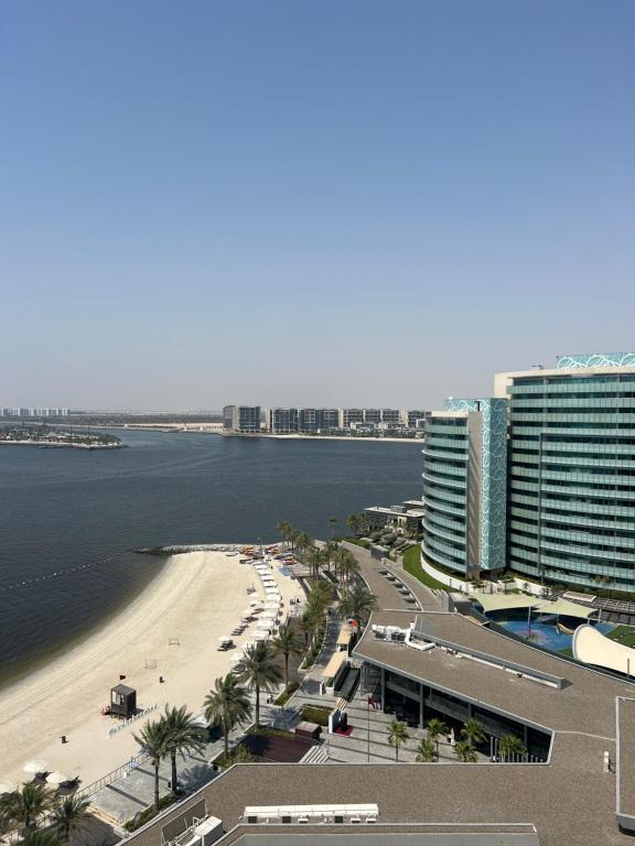 a view of a beach and buildings and the ocean at Luxury private sea view room in Abu Dhabi