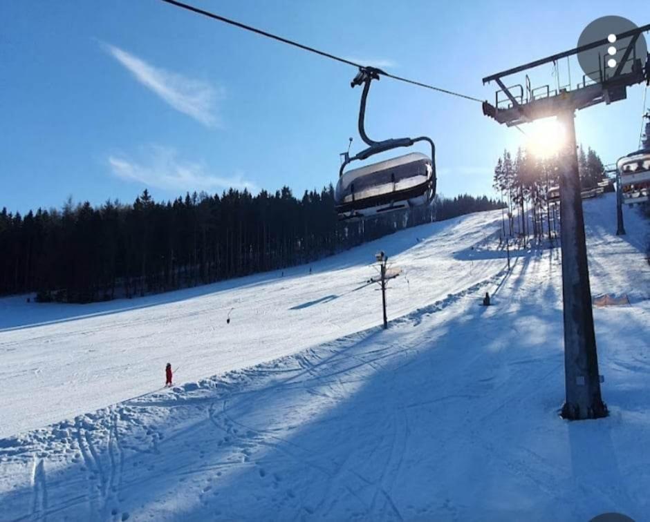 a ski lift on a snow covered ski slope at Chata Karlov pod Pradědem. Karlov in Malá Morávka