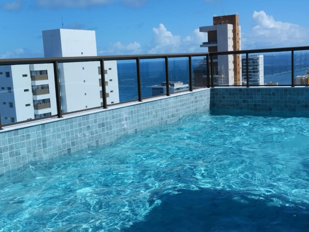 a swimming pool on the roof of a building at Barra Pinauna Studio in Salvador