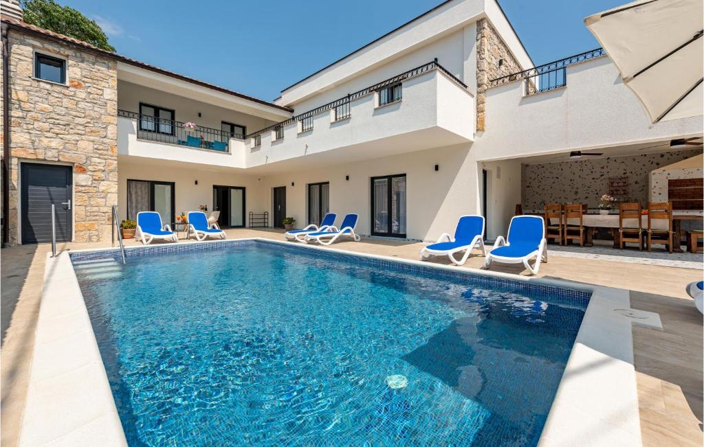 - une piscine avec des chaises et une maison dans l'établissement Awesome Home In Rastane Gornje With Wifi, à Gorica
